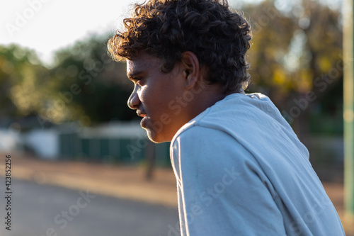 head and shoulders of aboriginal boy in profile photo