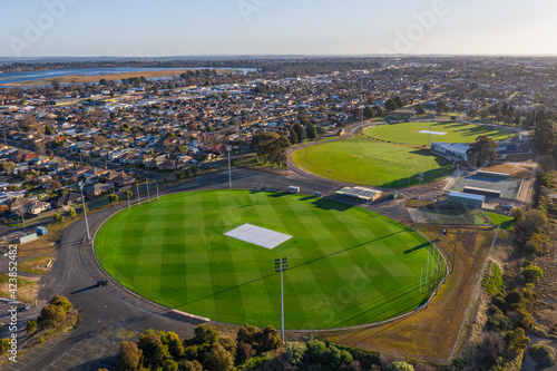 Aerial view of a series of AFL football ovals amongst suburban housing