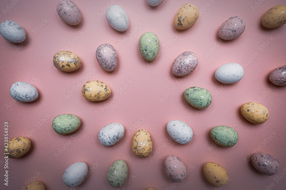 Colorful Easter eggs directed towards the center on purple background. Spring holidays concept Colorful Easter eggs directed towards the center on purple background. Spring holidays concept