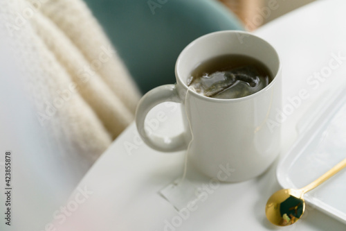 Mug with tea on table