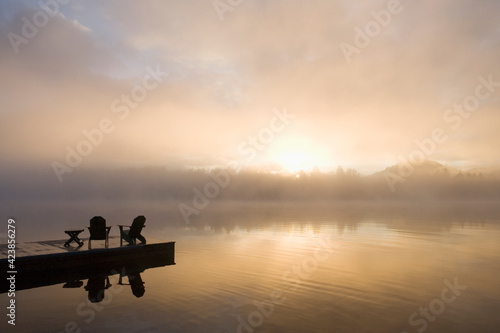USA, New York State, Adirondack State Park, Morning mist on lake in Adirondack Mountains