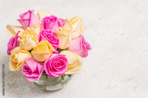 Fototapeta Naklejka Na Ścianę i Meble -  Bouquet of fresh multicolored roses in a vase