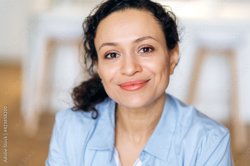 Female formal portrait. Close-up portrait of joyful successful elegant mixed race woman, business lady or assistant, dressed in formal shirt and glasses, looking at camera, smiling friendly Female formal portrait. Close-up portrait of joyful successful elegant mixed race woman, business lady or assistant, dressed in formal shirt and glasses, looking at camera, smiling friendly