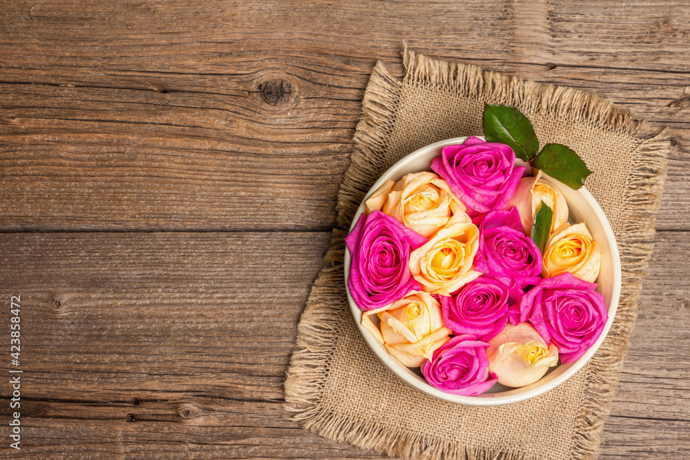 Composition of fresh multicolored roses in ceramic bowl Composition of fresh multicolored roses in ceramic bowl