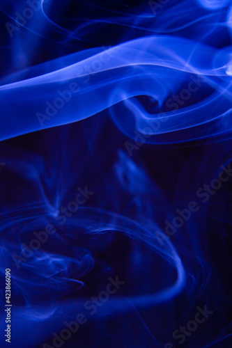 Lovely shape of blue smoke on a dark background. abstract smoke photograph. Wallpaper and background creative design.