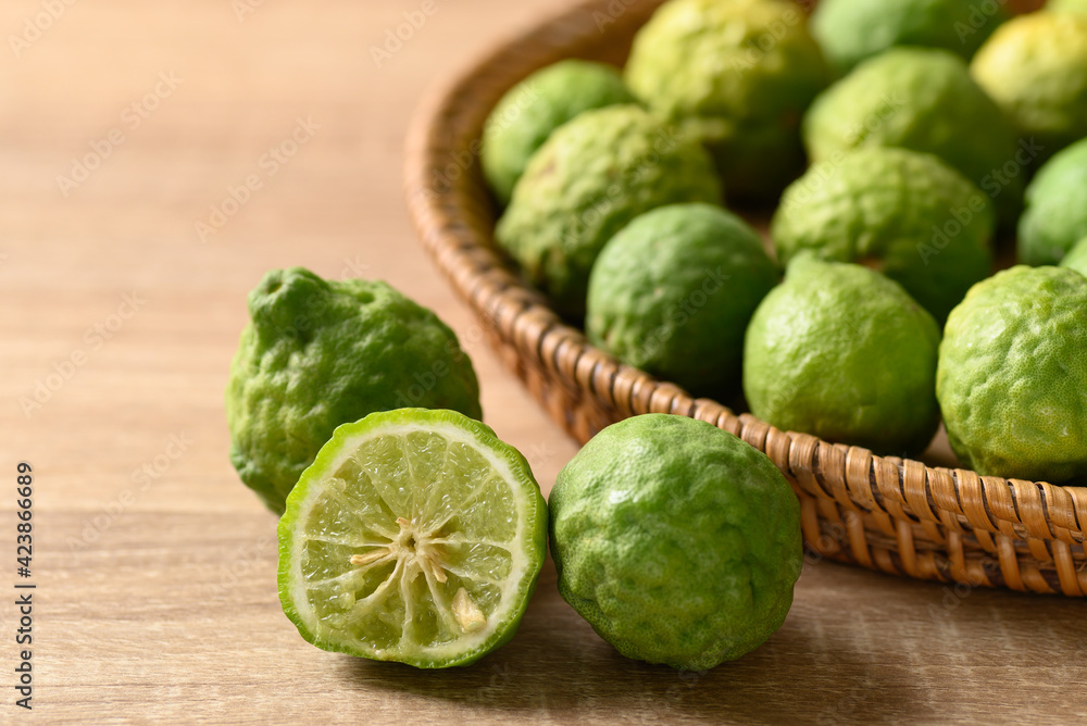 Fresh bergamot fruit in a basket on wooden table, Food ingredients and extract used for medicine, tea, perfumes and cosmetics Fresh bergamot fruit in a basket on wooden table, Food ingredients and extract used for medicine, tea, perfumes and cosmetics