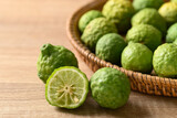 Fresh bergamot fruit in a basket on wooden table, Food ingredients and extract used for medicine, tea, perfumes and cosmetics
