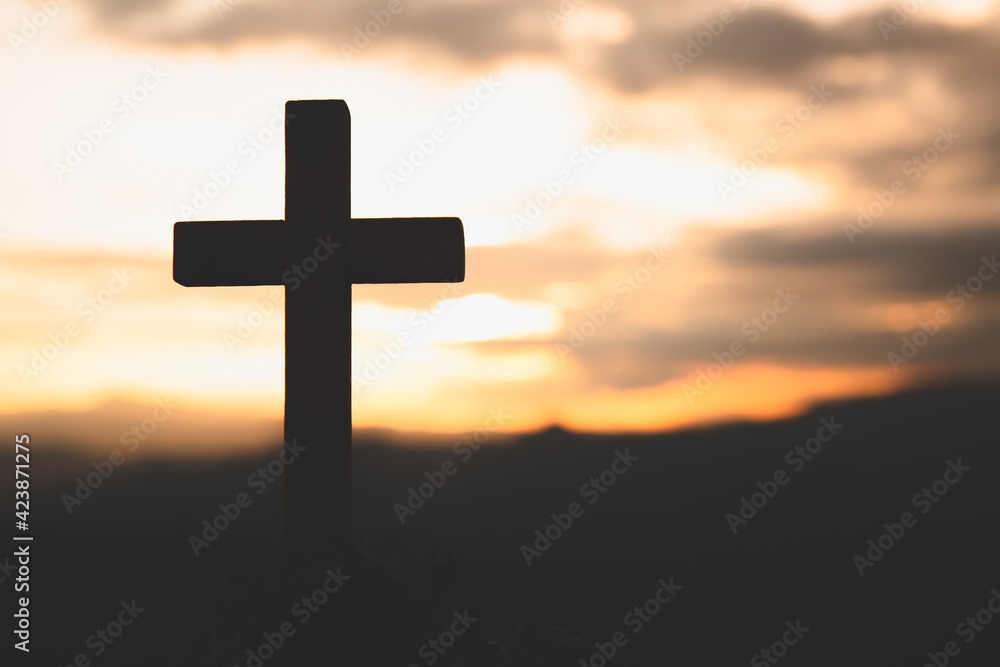 Religious concepts. Christian wooden cross on a background with dramatic lighting,  Jesus Christ cross, Easter, resurrection concept. Christianity, Religion copyspace background.