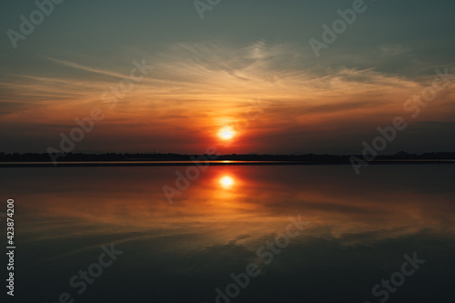 Colorful sunset landscape view of salt farm or salt pan in Thailand.