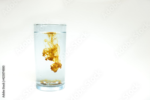 Tableau sur toile A single drop of concentrated Colloidal Silver being diluted in a glass of water