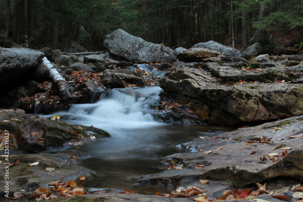 autumn waterfall flowing through mountain creek autumn waterfall flowing through mountain creek