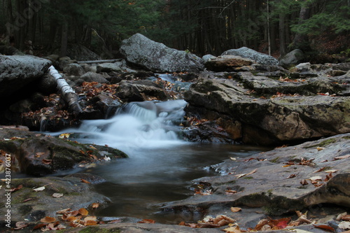 autumn waterfall flowing through mountain creek
