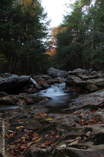 autumn waterfall flowing through mountain creek