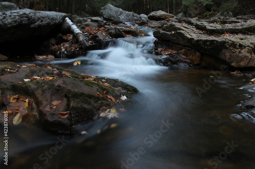 autumn waterfall flowing through mountain creek