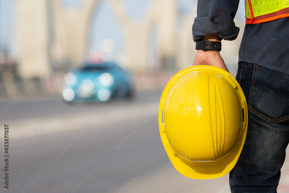 Engineer holding helmet on site Road construction For the development of modern transportation systems, Technician worker hold hard hat safety first Engineer holding helmet on site Road construction For the development of modern transportation systems, Technician worker hold hard hat safety first