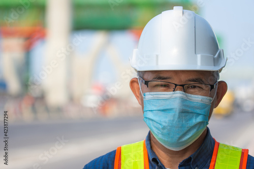 Close up Asian man engineer wear medical mask working in site construction, Old man concept retirement age