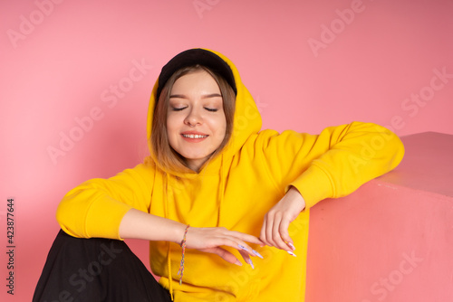 Girl in yellow hoodie and black cap © vkfoto