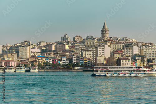 Turkey istanbul 04.03.2021. Famous galata tower of istanbul taken photo from istanbul bosporus. it is established by genoese sailors for watching of bosporus of constantinople. © SKahraman