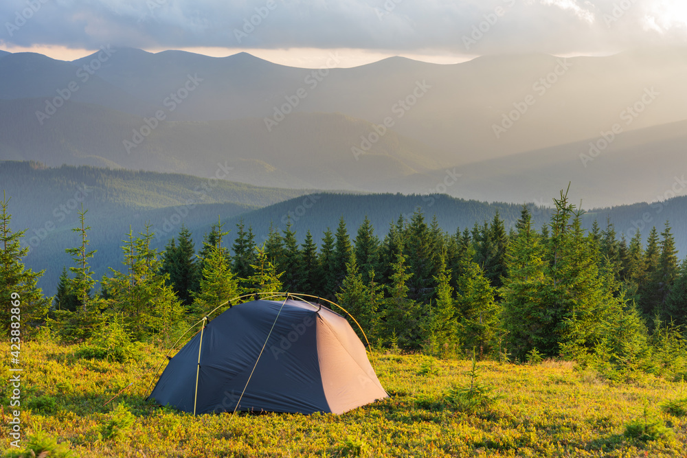Summer vacation in the mountains with a tourist tent with beautiful views around