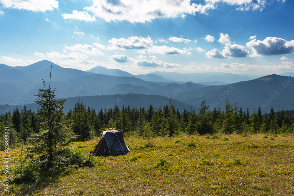 Summer vacation in the mountains with a tourist tent with beautiful views around