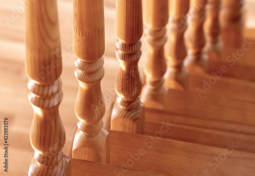 Obraz na plátně Element of a wooden interior staircase. Wooden baluster close-up.