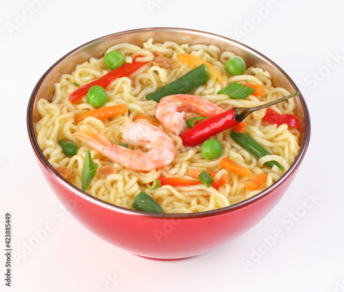 Chinese noodles with vegetables, soy sauce on a white plate