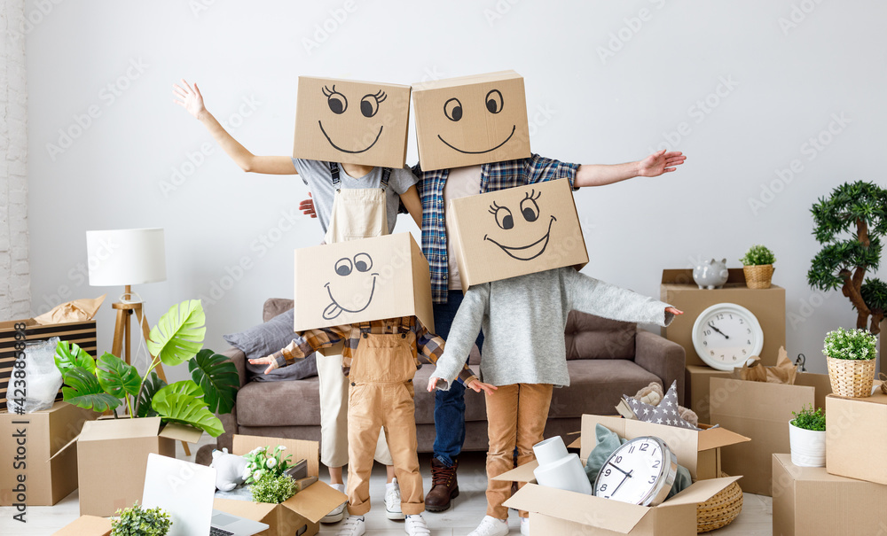 Family in carton boxes on heads in new apartment Family in carton boxes on heads in new apartment