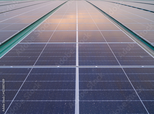 Foto Solar panels or solar cells on the rooftop of factory industry building