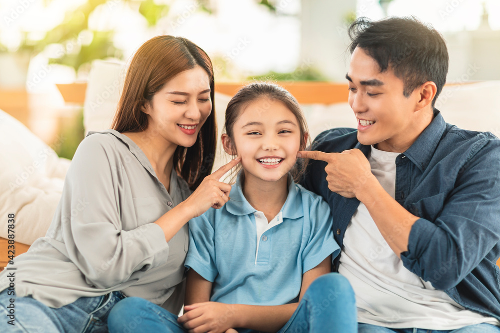 Happy family smiling on the couch at home Happy family smiling on the couch at home