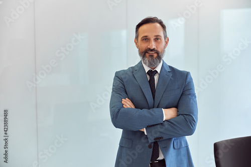 Happy adult caucasian man is working in a modern office