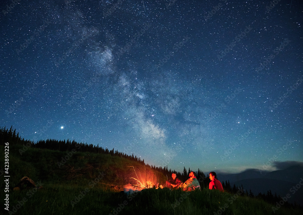Fototapeta premium Recreation under night full starry sky in the mountains.