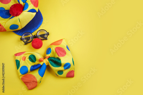 April Fool's Day background. Clown glasses and nose on yellow background