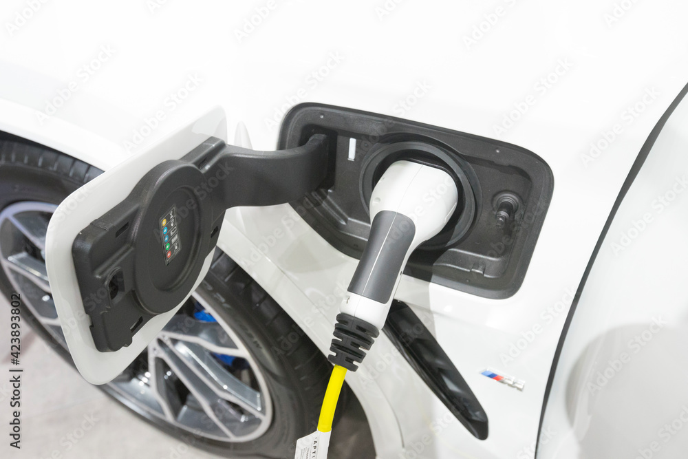 Close up view of vehicle electric charging socket plug in to recharge in Bangkok, Thailand. Close up view of vehicle electric charging socket plug in to recharge in Bangkok, Thailand.