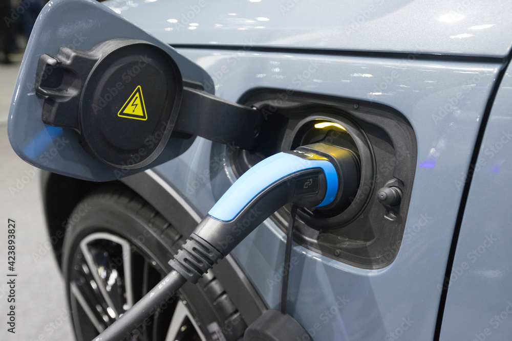 Close up view of vehicle electric charging socket plug in to recharge in Bangkok, Thailand. Close up view of vehicle electric charging socket plug in to recharge in Bangkok, Thailand.