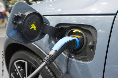 Close up view of vehicle electric charging socket plug in to recharge in Bangkok, Thailand.