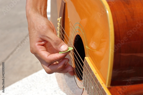 Playing acoustic guitar with a pick