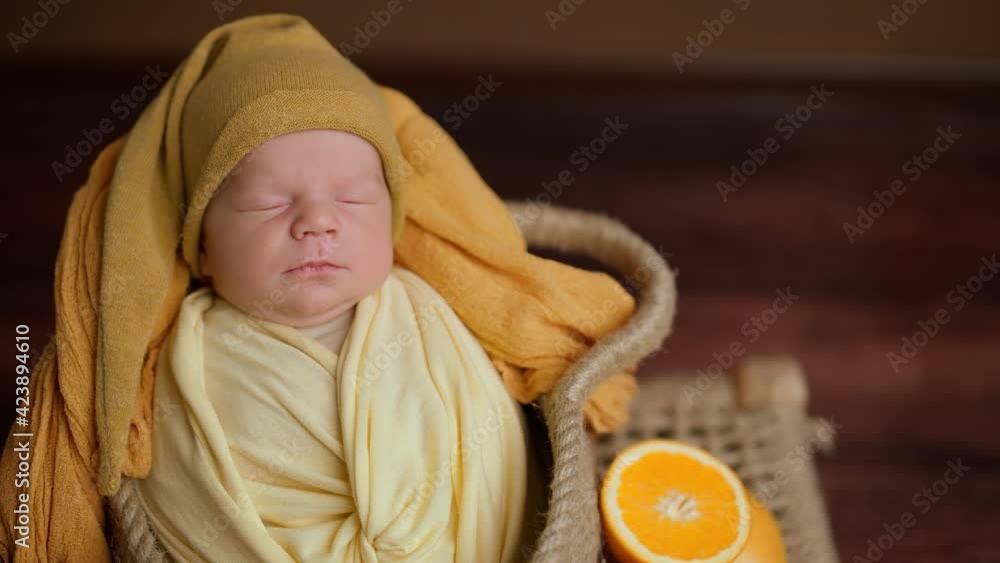 Peace and serenity, a newborn baby sleeping peacefully in a fruit basket, professional photography of children, still life. Peace and serenity, a newborn baby sleeping peacefully in a fruit basket, professional photography of children, still life.