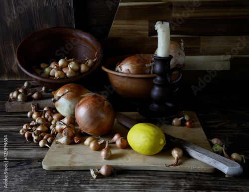 Onions among the pottery and candles.