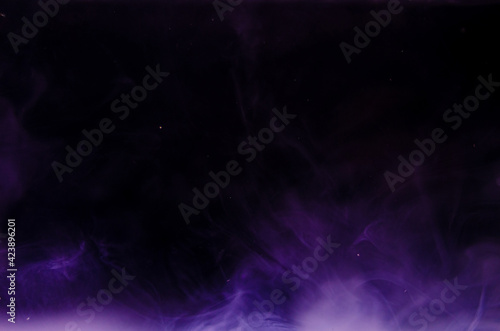 Ink swirls underwater. Ink cloud isolated on black background. Abstract effect of explosion of cosmos universe smoke with particles.