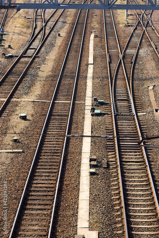 Rusty railroad tracks on gravel. Top view of railways on a sunny day