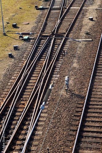 Rusty railroad tracks on gravel. Top view of railways on a sunny day