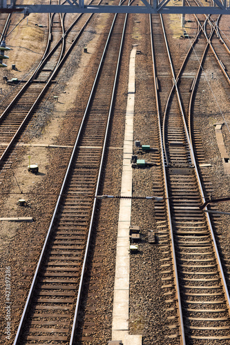Rusty railroad tracks on gravel. Top view of railways on a sunny day
