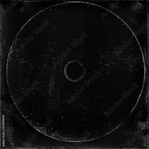 cd mark texture on paper for old cover art. grungy frame in black background. can be used to replicate the aged and worn look for your creative design. photo