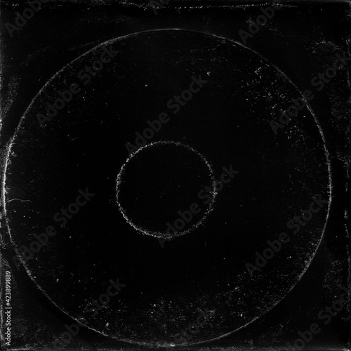 cd mark texture on paper for old cover art. grungy frame in black background. can be used to replicate the aged and worn look for your creative design.