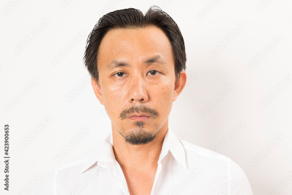 Head shot of middle aged Asian man looking at camera on white background. Head shot of middle aged Asian man looking at camera on white background.