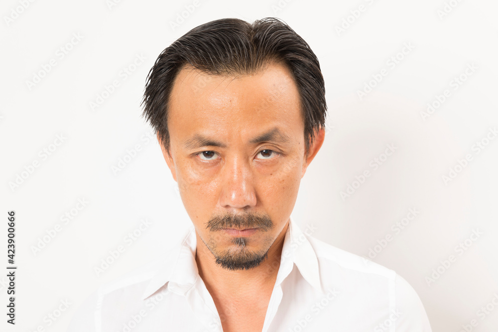 Head shot of middle aged Asian man looking at camera on white background. Head shot of middle aged Asian man looking at camera on white background.