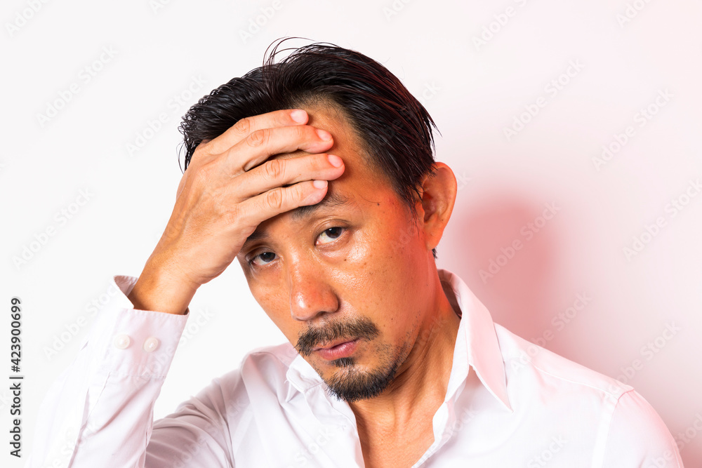 Head shot of middle aged Asian man looking at camera on white background. Head shot of middle aged Asian man looking at camera on white background.