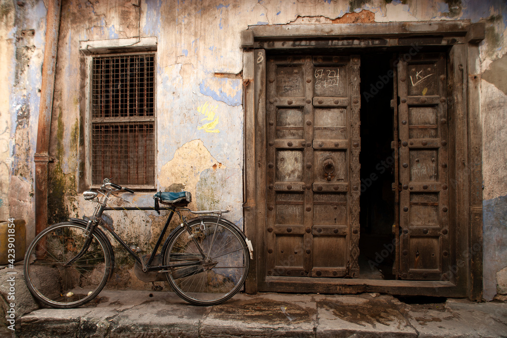 Old bicycle in front of a door opening at Zanzibar island in Tanzania in Africa