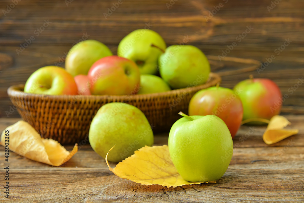 Basket with tasty apple and pear fruits on wooden background Basket with tasty apple and pear fruits on wooden background
