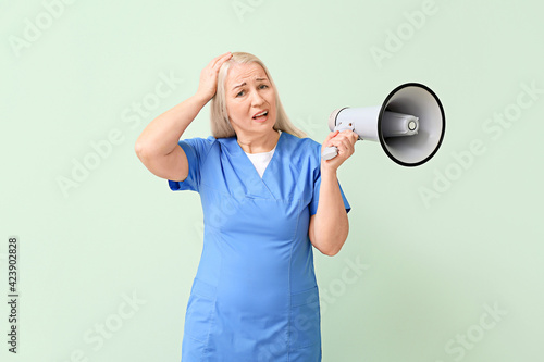 Mature female doctor with m...